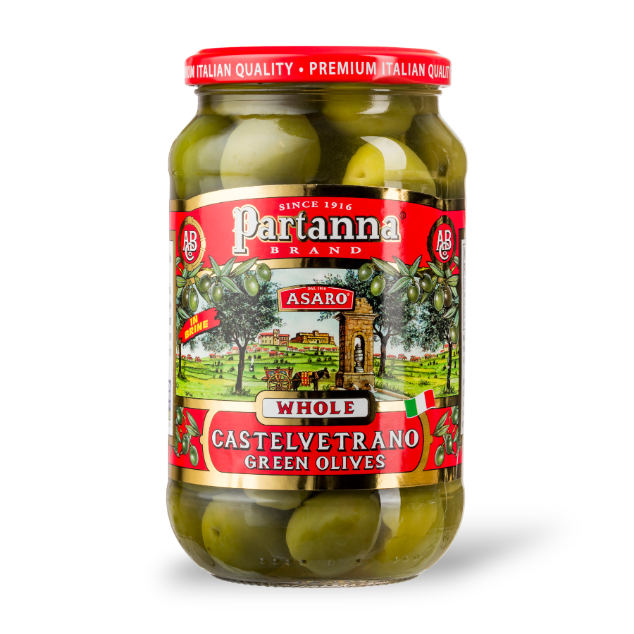 A jar of Partanna Whole Castelvetrano Green Olives with a red label, showcasing the olives and the landscape of Italy.
