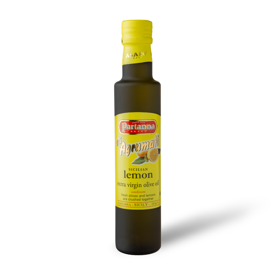 A bottle of Partanna Sicilian Lemon Extra Virgin Olive Oil with dark glass and a yellow cap, labeled with the product name and lemon graphics.
