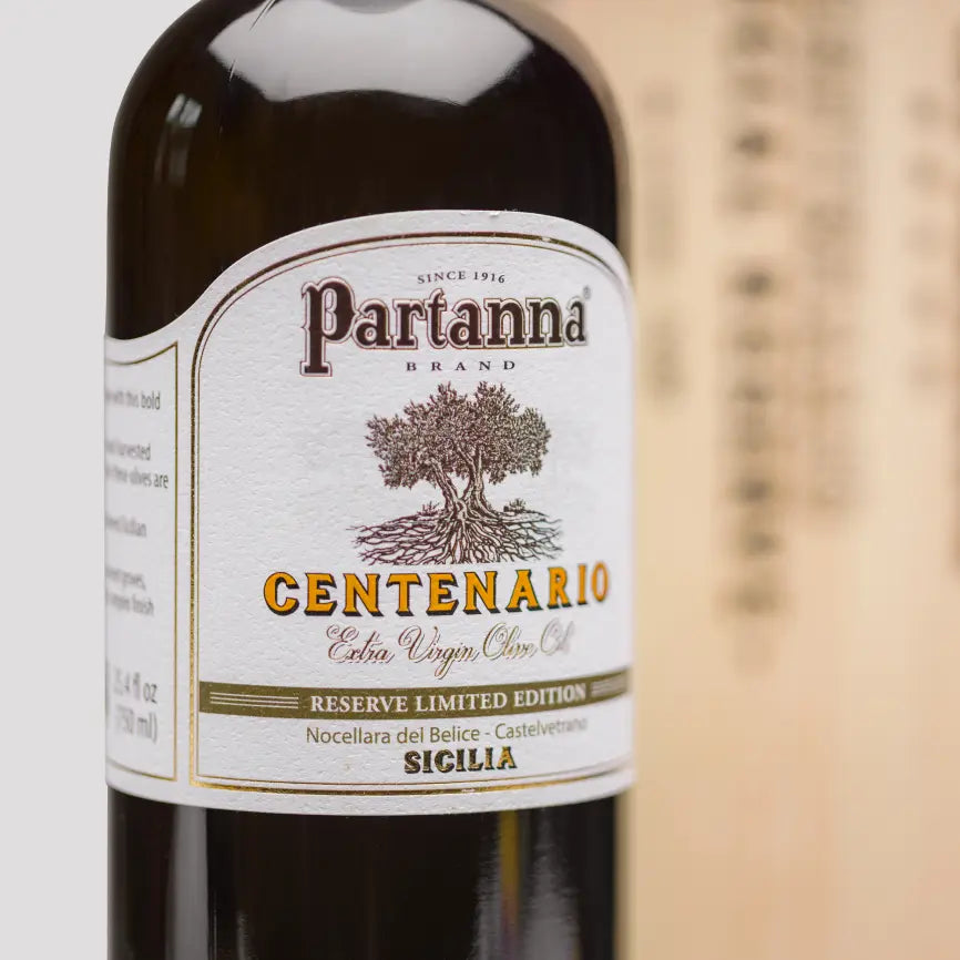 Partanna olive oil bottle with wooden box on a white background