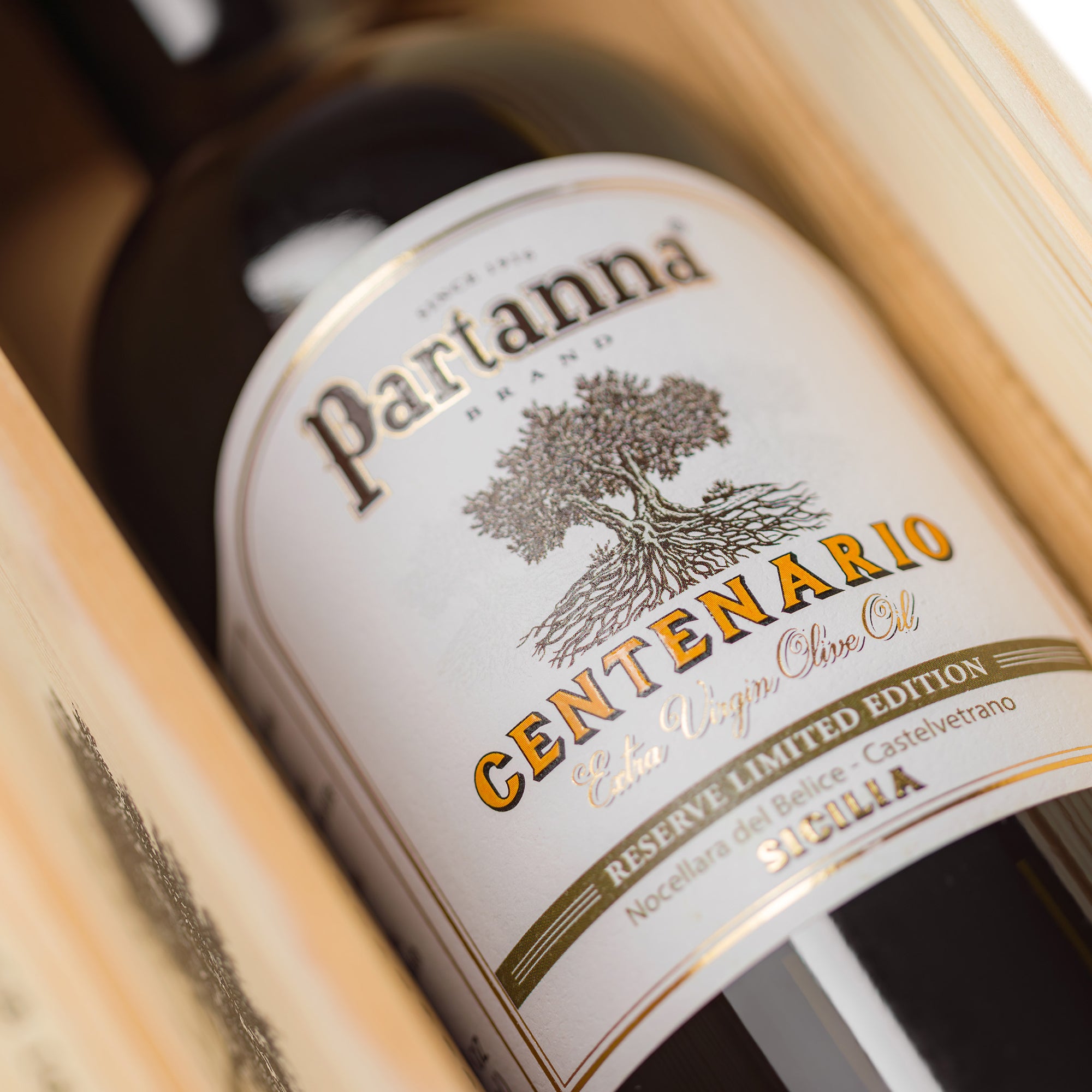 Close-up of a Partanna Centenario olive oil bottle label.