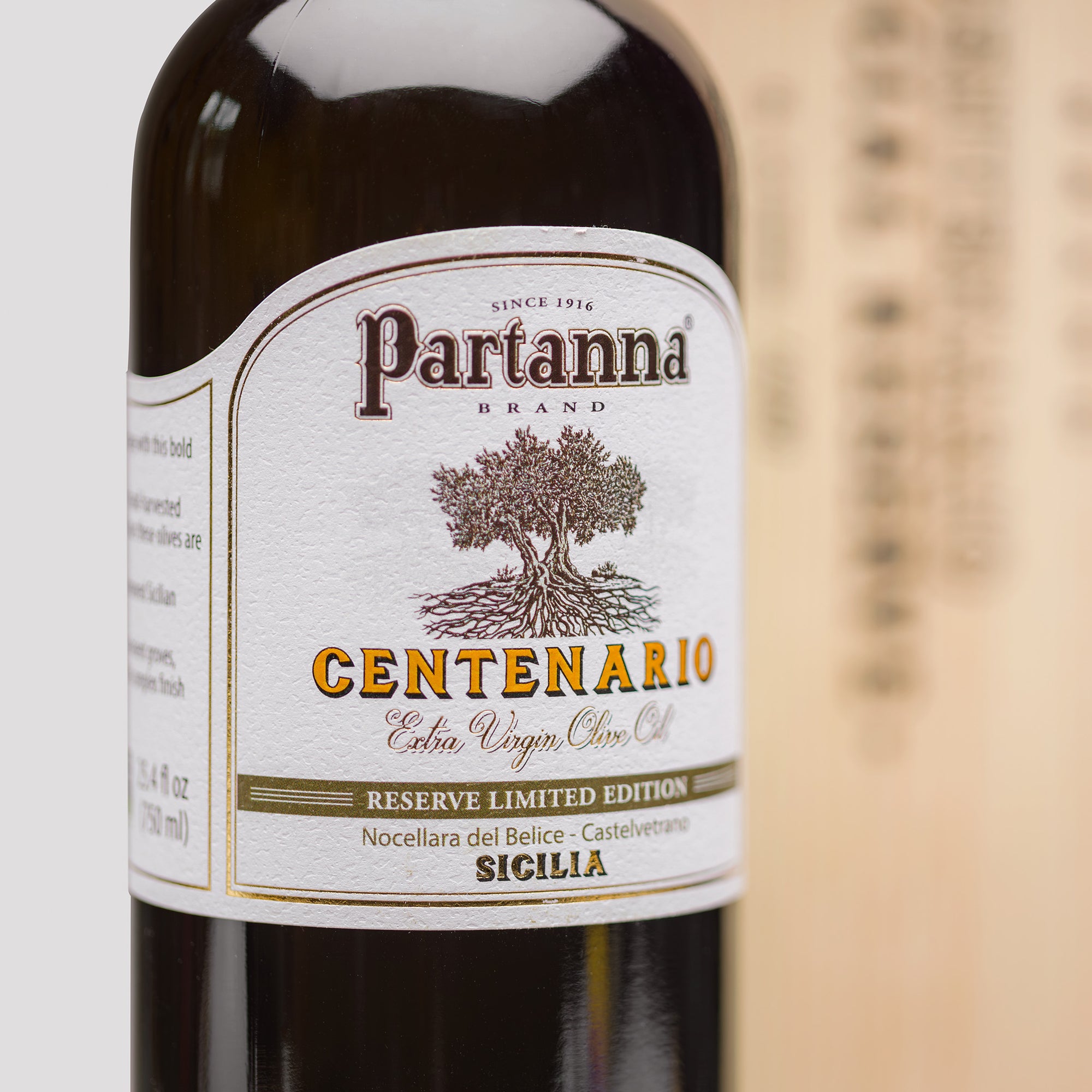 Partanna Centenario olive oil bottle with label on a white background