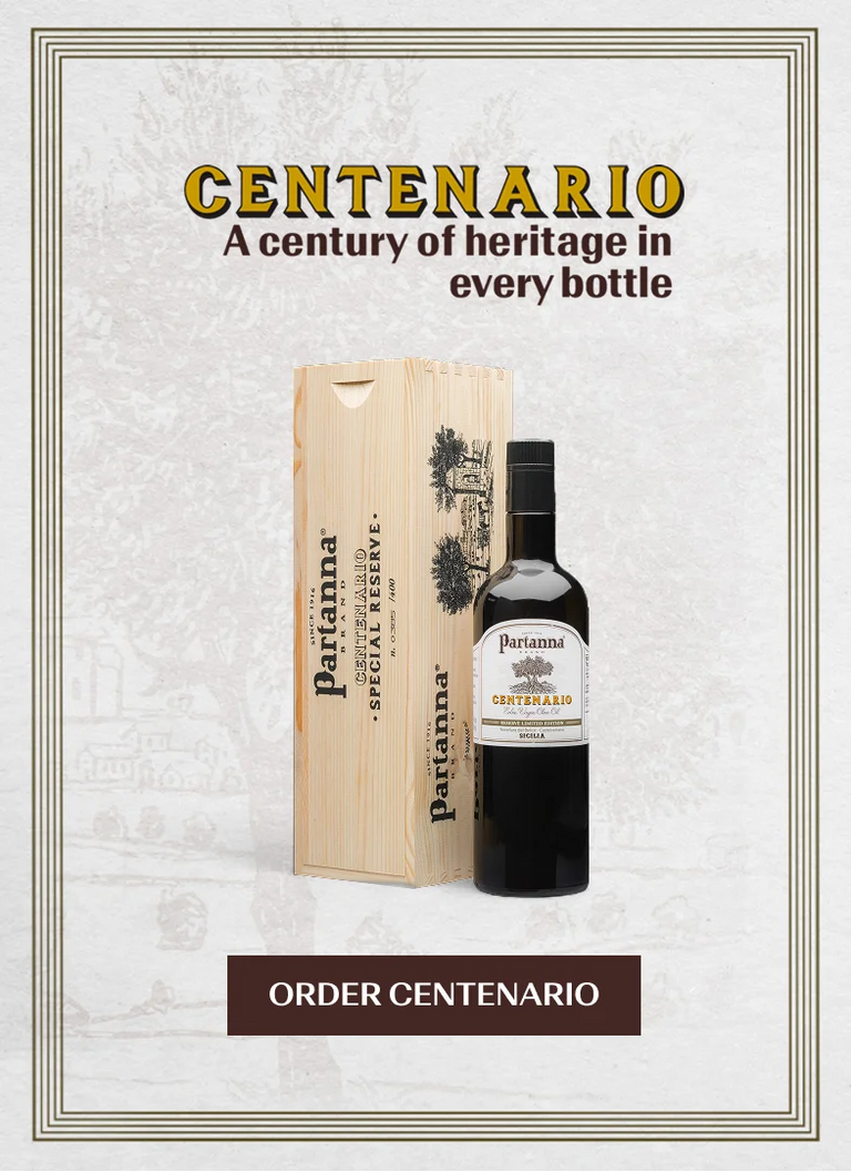 Partanna Centenario bottle and wooden box on a textured white background